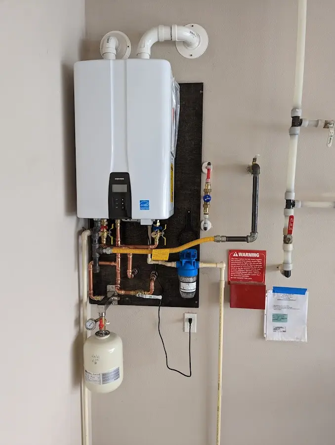 Professional plumber installing copper piping in a Red Bank home